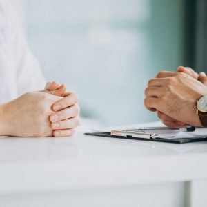 Physician consulting his patient at clinic